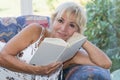 Attractive mature blond woman is reading a book Royalty Free Stock Photo