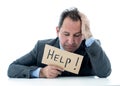 Attractive mature businessman overwhelmed and tired holding a help sign Royalty Free Stock Photo