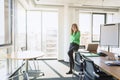 Attractive mature businesswoman making a call while sitting at the office and working Royalty Free Stock Photo