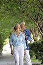 Attractive mature couple posing on a green tree background Royalty Free Stock Photo