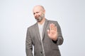 Attractive mature man showing refusal gesture. It is not for me, leave me in piece, has angry expression Royalty Free Stock Photo