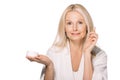 attractive mature woman applying cosmetic cream Royalty Free Stock Photo