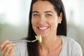 Attractive mature woman eating salad Royalty Free Stock Photo