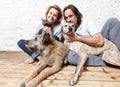 Attractive man and his young wife with pets, two dogs and a cat, a family portrait Royalty Free Stock Photo