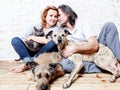 Attractive man and his young wife with pets, two dogs and a cat, a family portrait Royalty Free Stock Photo