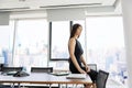Attractive mid aged businesswoman sitting in a modern office Royalty Free Stock Photo