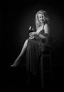 Attractive middle age woman in evening dress with glass of red wine Royalty Free Stock Photo