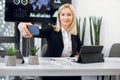 Attractive middle aged blond woman in business wear, ceo, secretary or manager, taking a picture of herself with a phone Royalty Free Stock Photo