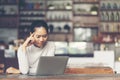 An attractive middle aged businesswoman sitting in front of laptop and managing her small business from home. Royalty Free Stock Photo