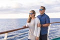 Attractive middle-aged couple enjoying the balcony view from the deck of a cruise ship Royalty Free Stock Photo