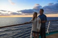 Attractive middle-aged couple enjoying the sunset view from the deck of a cruise ship Royalty Free Stock Photo