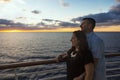 Attractive middle-aged couple enjoying the sunset view from the deck of a cruise ship Royalty Free Stock Photo