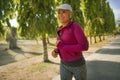 Attractive middle aged lady running happy at city park . beautiful and sporty woman on her 40s exercising doing jogging workout on Royalty Free Stock Photo