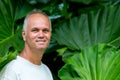 Attractive middle-aged man with Philodendron