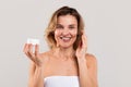 Attractive Middle Aged Woman Applying Moisturising Cream On Face Royalty Free Stock Photo