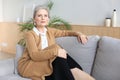 Attractive middle aged woman relaxing in sofa at home Royalty Free Stock Photo
