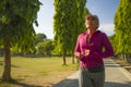 Attractive middle aged woman running happy at city park . beautiful and sporty lady on her 40s exercising doing jogging workout on Royalty Free Stock Photo