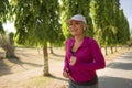 Attractive middle aged woman running happy at city park . beautiful and sporty lady on her 40s exercising doing jogging workout on Royalty Free Stock Photo