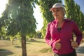 Attractive middle aged woman running happy at city park . beautiful and sporty lady on her 40s exercising doing jogging workout on Royalty Free Stock Photo