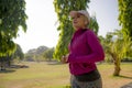 Attractive middle aged woman running happy at city park . beautiful and sporty lady on her 40s exercising doing jogging workout on Royalty Free Stock Photo