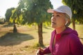 Attractive middle aged woman running happy at city park . beautiful and sporty lady on her 40s exercising doing jogging workout on Royalty Free Stock Photo