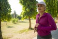 Attractive middle aged woman running happy at city park . beautiful and sporty lady on her 40s exercising doing jogging workout on Royalty Free Stock Photo