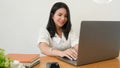 Female college student using laptop computer, doing her project Royalty Free Stock Photo