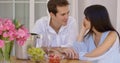 Attractive mixed couple having wine together Royalty Free Stock Photo