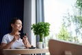 Attractive mixed race woman enjoying coffee break time in cafe. Woman drinking coffee Royalty Free Stock Photo