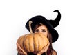 Attractive model girl in Halloween costume. Halloween concept. Beautiful young woman in black witch costume with hat Royalty Free Stock Photo