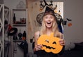 Attractive model girl in Halloween costume. Halloween Witch with pumpkin. Beautiful young woman in black witch costume Royalty Free Stock Photo