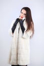 Attractive model in mink fur coat on white background Royalty Free Stock Photo