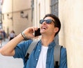 Handsome modern happy young man talking on his smart phone outsi Royalty Free Stock Photo