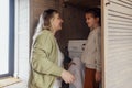 attractive mom and her cute baby are doing household chores