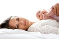 Attractive mother lying in bed with newborn baby