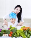 Attractive mother and son preparing a salad