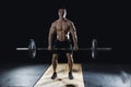 Attractive muscular bodybuilder doing deadlifts in modern fitne