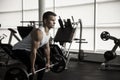 Attractive muscular bodybuilder doing heavy deadlifts in modern fitness center