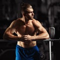 Attractive muscular bodybuilder guy prepare to do exercises with barbell in a gym Royalty Free Stock Photo