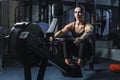 Attractive muscular woman CrossFit trainer do workout on indoor rower Royalty Free Stock Photo