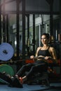 Attractive muscular woman CrossFit trainer do workout on indoor rower Royalty Free Stock Photo