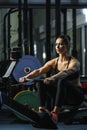 Attractive muscular woman CrossFit trainer do workout on indoor rower Royalty Free Stock Photo