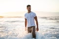 Attractive muscular young athletic man standing in the ocean Royalty Free Stock Photo