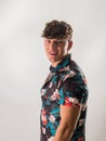 Attractive, muscular young man smiling, wearing open hawaian style shirt Royalty Free Stock Photo