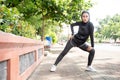 muslim asian woman strecth her leg during sport time outdoor Royalty Free Stock Photo