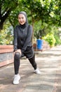 muslim asian woman strecth her leg during sport time outdoor Royalty Free Stock Photo