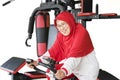 Muslim senior woman riding exercise bike Royalty Free Stock Photo