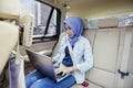 Attractive muslim woman using a laptop in car