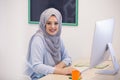 Attractive Muslim young woman working in office on computer Royalty Free Stock Photo