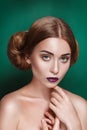 Attractive mysterious young woman with double hair bun in Princess Leia hairstyle looks towards the camera Royalty Free Stock Photo